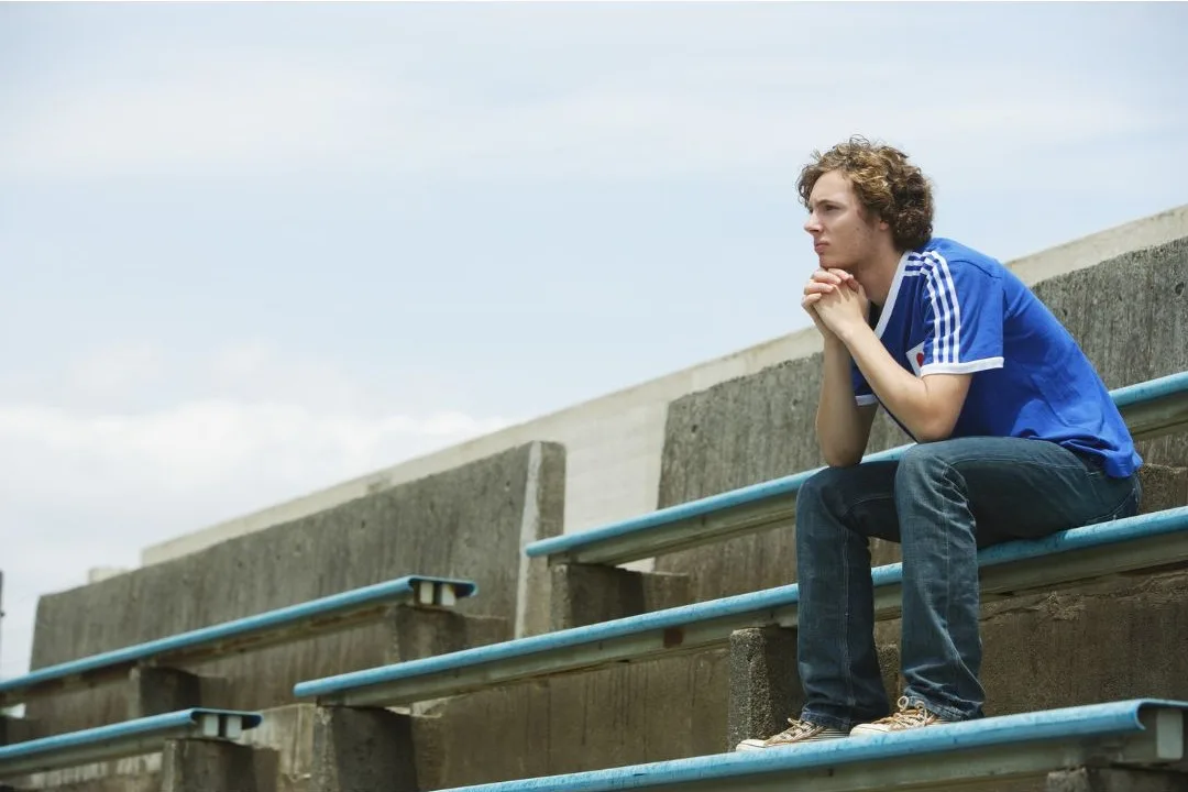 Young returned missionary sitting alone contemplating his next steps